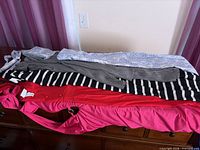 Four dresses stacked showing colours and fabrics