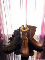 Both pairs of boots side by side on surface