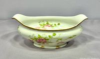 Side view showing floral design and gold trim