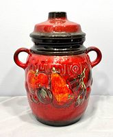 Front view of Scheurich red rumtopf jar with lid and handles
