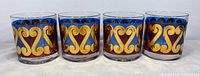 Front view of four glasses showing decorative pattern