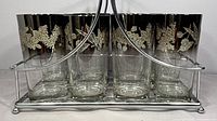 front view of eight glasses in chrome carrier