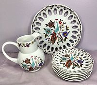 Full set showing pitcher, large plate, stack of five plates
