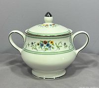 Full view of lidded sugar bowl showing shape, handles and finial