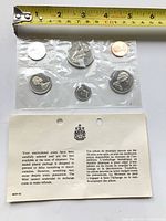 Front view of sealed coin set showing all four denominations