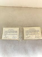Two sealed medallion packages with certificates