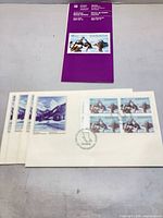 Lot overview showing purple information card and three of the four FDC envelopes