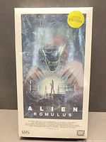 Front view of sealed Alien: Romulus VHS showing artwork and Limited Edition sticker