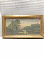 Front view of framed oil landscape painting