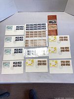 Group shot of all items: two sheets, booklet, eight FDCs