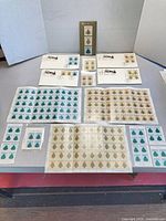 Overall view of sheets, blocks and first day covers laid out on table