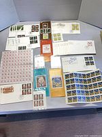 Overall view of stamp sheets, booklets and FDCs on table