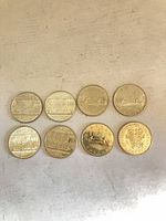 Group shot of all eight coins, obverse designs visible