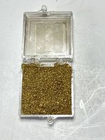 Open case showing quantity and appearance of gold filings