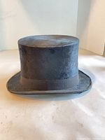 Front view of black silk top hat