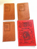 Front view of three brown stockbooks and one red album