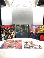 Front view of all five LP covers displayed upright