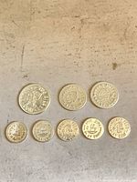 Front view of all eight silver-tone play coins showing denominations and relative sizes