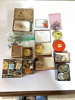 Overview of all boxed and loose watch parts on table