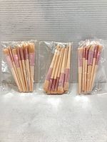 three sealed brush sets side by side