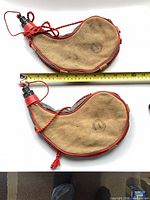 Both bota bags side by side with tape measure for scale