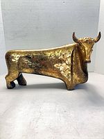 Front view showing full bull form and gilt finish