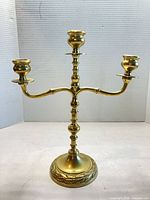 Full view of brass three-arm candelabra