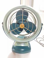 Front view of Vornado 16-C fan showing grille, blades, logo hub and base