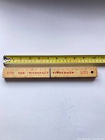 Knife closed showing dishonest fishermen side with ruler, tape measure for scale