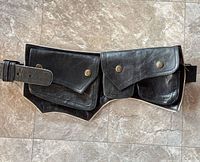 Front view showing dual flap pockets and strap