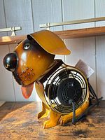 Left side view of dog-shaped fan showing rear fan cage and cord