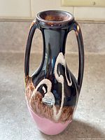 Front view of handled drip-glaze vase