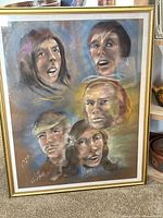 Full view of framed pastel and charcoal portrait showing five faces