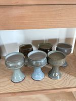Front view of six stoneware goblets on shelf
