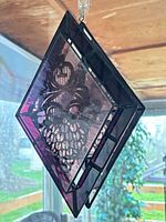 Hanging view showing purple glass, grape motif, diamond geometry, hanging ring