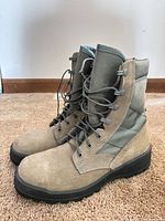 lateral view of both boots showing uppers, laces and materials