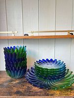 Stacked petal-form vase left; stacked swirl plates right