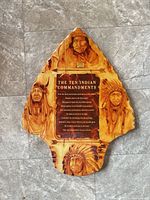 Front of wooden arrowhead plaque showing imagery and text