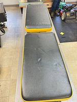 Top view of both padded sections showing black vinyl with yellow trim