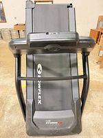 Front view of Bowflex BXT6 treadmill folded upright
