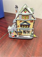 Yellow brick house style building with snow accents