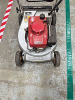 Top view showing red Honda engine on silver 21-inch steel deck