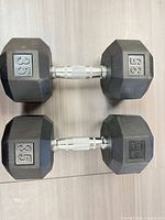 Top view of both 35 lb dumbbells showing hex shape and knurled handles