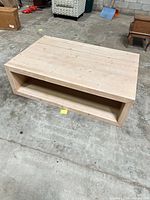 Full view of pine coffee table from front showing open shelf