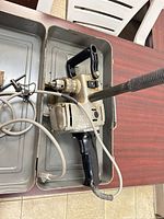 Angle drill in metal carry case with cord and accessories