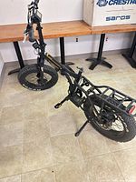 Full view of RadMini folding e-bike showing fat tires, rear rack, folding frame
