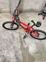 Left side view of entire red kids bike