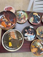 View of several Knowles Norman Rockwell plates on table