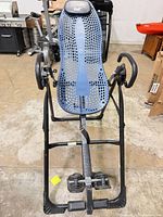 Full view of Teeter Hang Ups inversion table showing frame, bed and ankle lock