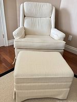 Front view of ivory wingback chair and ottoman